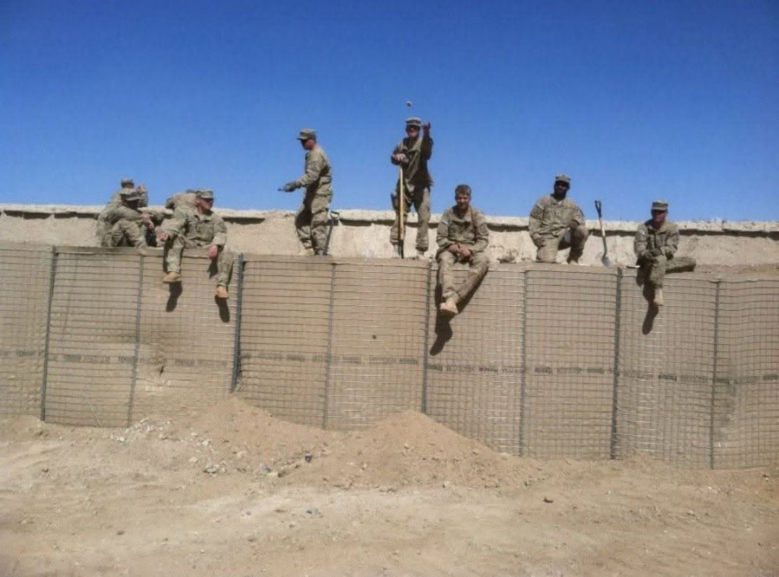 Military service photo with soldiers on a wall